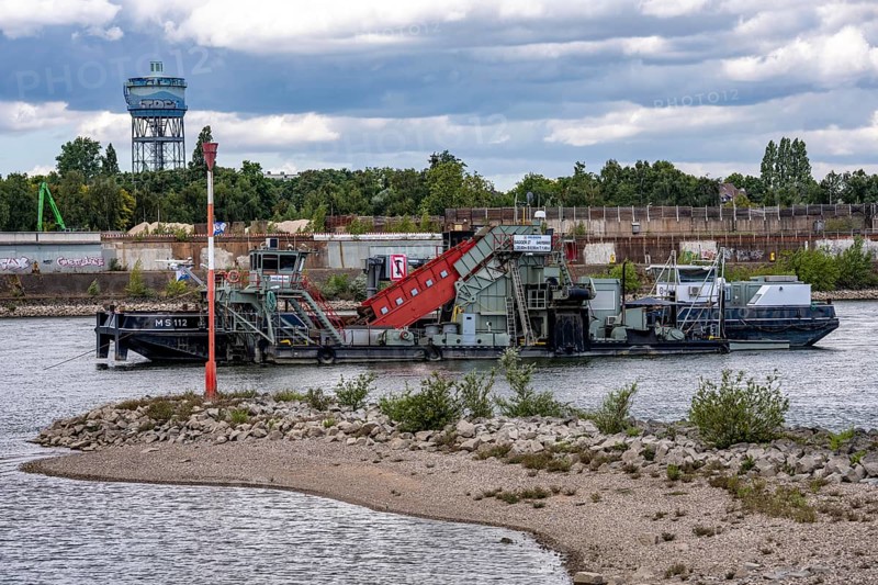 Bucket chain dredger at work on the Rhine near Duisburg, between the Neuenkamper Rhine Bridge and the Friedrich-Ebert Bridge in Ruhrpott, dredging the navigation channel, North Rhine-Westphalia, Germany