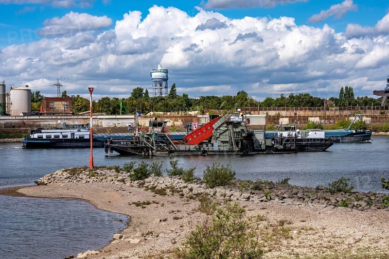 Bucket chain dredger at work on the Rhine near Duisburg, between the Neuenkamper Rhine Bridge and the Friedrich-Ebert Bridge in Ruhrpott, dredging the navigation channel, North Rhine-Westphalia, Germany