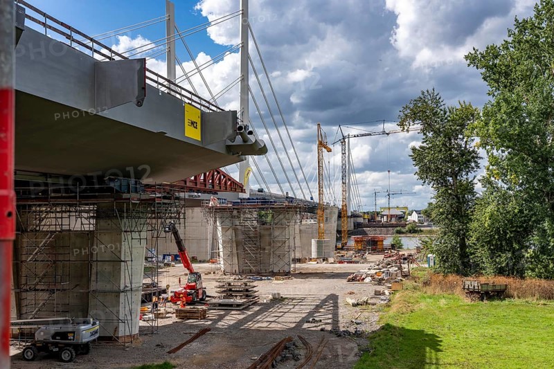 New construction of the second motorway bridge Neuenkamp of the A40, over the Rhine near Duisburg, parallel to the already existing first bridge, most of the new bridge piers are in place, two first bridge segments are finished and have already been moved towards the river on both sides of the Rhine, full completion is planned for 2028, North Rhine-Westphalia, Germany
