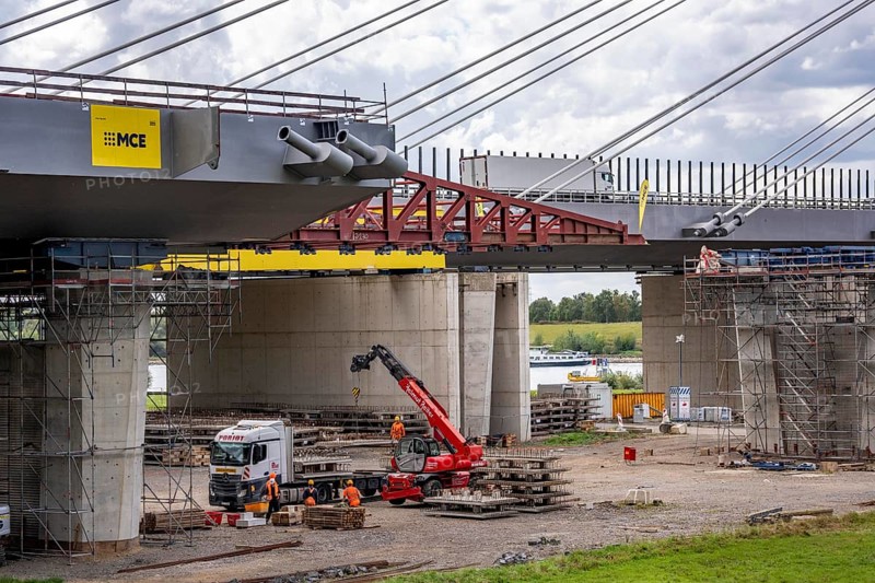 New construction of the second motorway bridge Neuenkamp of the A40, over the Rhine near Duisburg, parallel to the already existing first bridge, most of the new bridge piers are in place, two first bridge segments are finished and have already been moved towards the river on both sides of the Rhine, full completion is planned for 2028, North Rhine-Westphalia, Germany