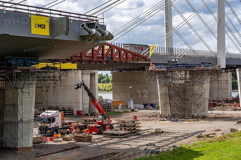 New construction of the second motorway bridge Neuenkamp of the A40, over the Rhine near Duisburg, parallel to the already existing first bridge, most of the new bridge piers are in place, two first bridge segments are finished and have already been moved towards the river on both sides of the Rhine, full completion is planned for 2028, North Rhine-Westphalia, Germany