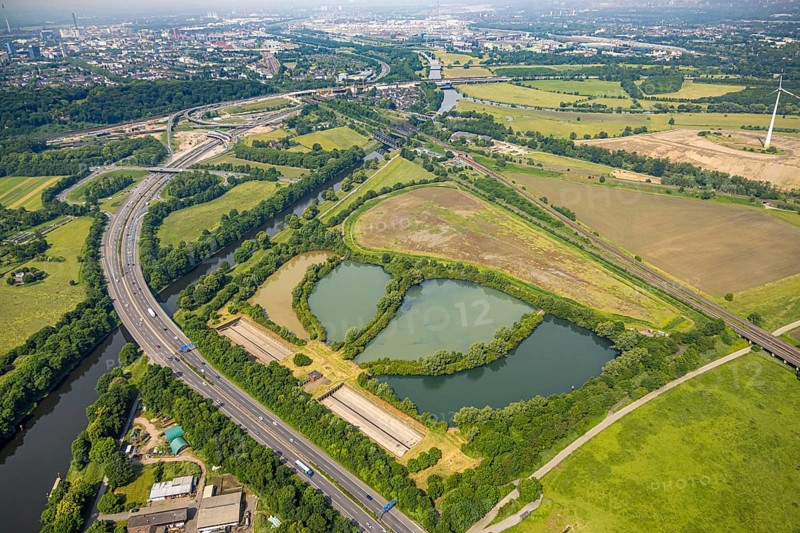 Aerial view, Große Ruhrinsel Klärschlammdeponie am Schifffahrtskanal der Ruhr, motorway A40 and Ruhrbrücke, behind the motorway junction Kaiserberg, railway tracks and railway bridges Brückenlandschaft Ruhraue, Oberhausen, Ruhr area, North Rhine-Westphalia, Germany, DE, landfill, Europe, aerial view, aerial photography, aerial photography, overview, bird's-eye view, overview, OberhausenSued