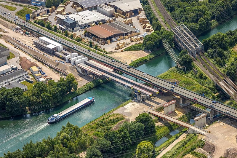 Aerial view, construction site with new construction, railway bridge Emscherbrücke Rollbahn, motorway A43 with bridge over Rhine-Herne Canal, Baukau, Herne, Ruhr area, North Rhine-Westphalia, Germany, A43, architecture, motorway, construction work, construction area, construction site, construction sites, Baukau-West, construction measure, construction project, construction site, construction site vehicles, bridge, bridge construction, DE, railway bridge, Emscherbrücke, Europe, river, water, large construction site, industry, industrial site, infrastructure, infrastructure project, canal, construction, landscape, aerial view, aerial photography, aerial photography, metal processing, Rhine-Herne Canal, runway, Ruhr area scene, rail, sinter works, city, road, transport, overview, urban, traffic, bird's-eye view, birds-eyes view, modern architecture, overview, linksderA43, HernelinksderA43