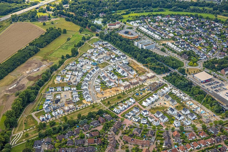 Aerial view, Duisburg-Süd, residential area Angerbogen, Am Alten Angerbach, semi-circular new housing estate, commercial area Xella International GmbH and Edeka E-Center Angerbogen, roofed railway station Angerbogen, behind the Rahmer See, Huckingen, Duisburg, Ruhr area, North Rhine-Westphalia, Germany