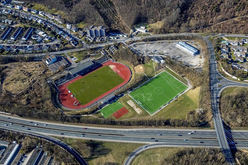 Aerial view, Erich-Berlet-Stadion, formerly Kirchenbergstadion, football stadium and athletics stadium with adjacent pitch, on the A46 motorway, refugee accommodation container village Kirchenberg, Hohenlimburg, Hagen, Ruhr area, North Rhine-Westphalia, Germany