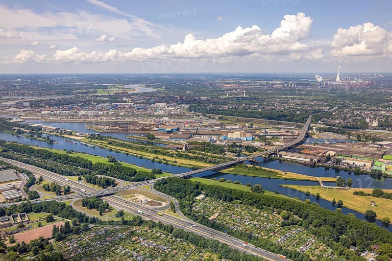 Aerial view, Berlin bridge of motorway A59 over river Ruhr and Rhine-Herne-Canal between motorway junction Duisburg and harbour Duisburg, allotment garden association Ruhrwiesen, distant view and blue sky with clouds, Duissern, Duisburg, Ruhr area, North Rhine-Westphalia, Germany