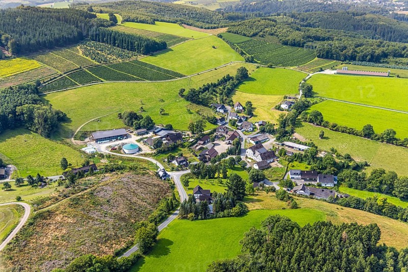 Aerial view, residential area local view district Büemke with chapel St. Agatha, meadows and fields and wooded hilly landscape, Christmas tree cultivation, Reiste, Eslohe, Sauerland, North Rhine-Westphalia, Germany, agriculture, place of worship, farm, DE, Europe, religious community, place of worship, holy place, hilly landscape, church, agriculture, agricultural fields, farm, aerial view, aerial photography, aerial photography, Meschede, religion, religious site, Ruhr area, overview, bird's-eye view, meadows and fields, meadow landscape, birds-eyes view, overview