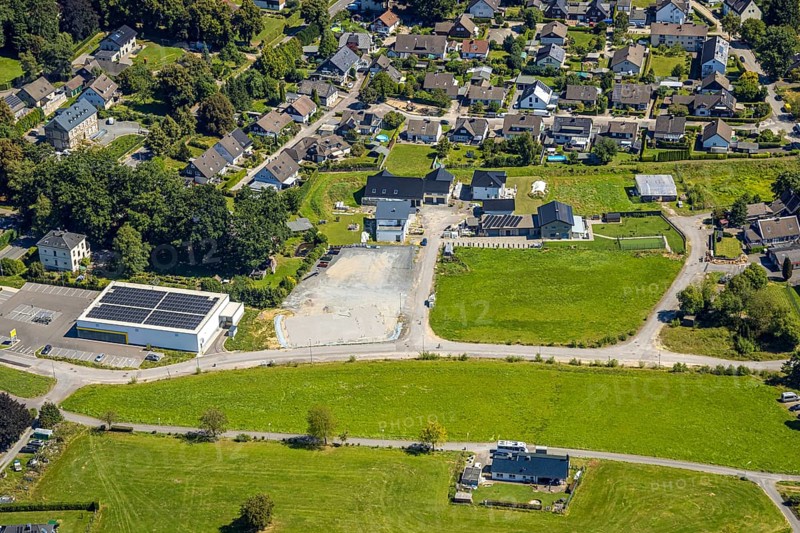 Aerial view, residential area local view district Rönsahl with Netto supermarket and solar roof, Meienborn, Rönsahl, Kierspe, Sauerland, North Rhine-Westphalia, Germany, DE, roof with solar panels, Europe, property tax, real estate, aerial view, aerial photography, aerial photography, photovoltaic plant, Ruhr area, chimney, solar, solar plant, solar roof, solar energy, solar panels, solar power plant, overview, bird's-eye view, residential complex, living and life, residential area, quality of life, residential neighbourhood, housing estate, residential area, birds-eyes view, overview
