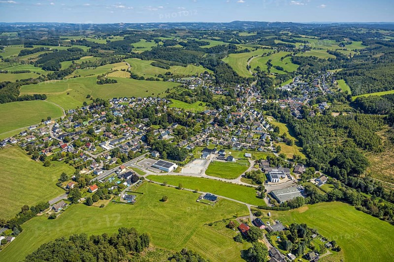 Aerial view, residential area local view district Rönsahl with historical distillery Rönsahl, sight, in front Netto supermarket with solar roof and Ernst Wilhelm Julius GmbH, Meienborn, hilly landscape with distant view, Rönsahl, Kierspe, Sauerland, North Rhine-Westphalia, Germany, DE, roof with solar panels, Europe, property tax, real estate, aerial view, aerial photography, aerial photography, photovoltaic plant, Ruhr area, chimney, solar, solar plant, solar roof, solar energy, solar panels, solar power plant, overview, bird's eye view, residential complex, living and life, residential area, residential quality, residential neighbourhood, housing estate, residential district, birds-eyes view, overview