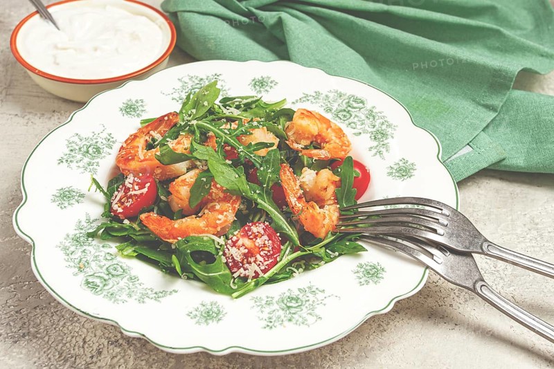 Shrimp salad with arugula and cherry tomatoes, with parmesan cheese, healthy food