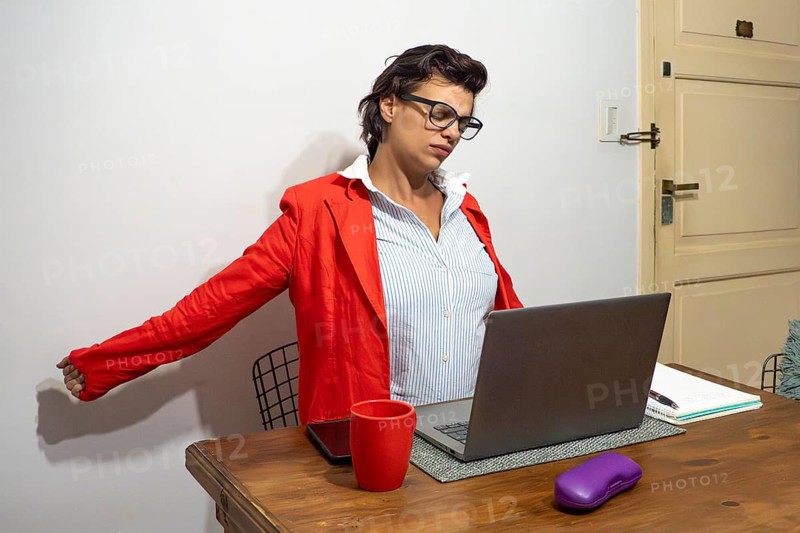 Professional woman taking a much-needed stretching break from work