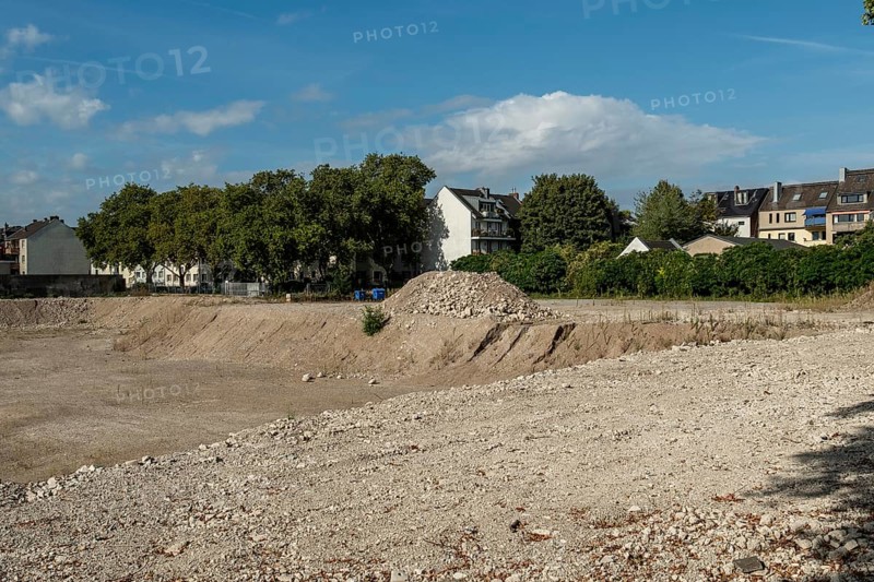 Excavation pit with houses in the background, Ehrenfeld, Cologne, North Rhine-Westphalia, Germany