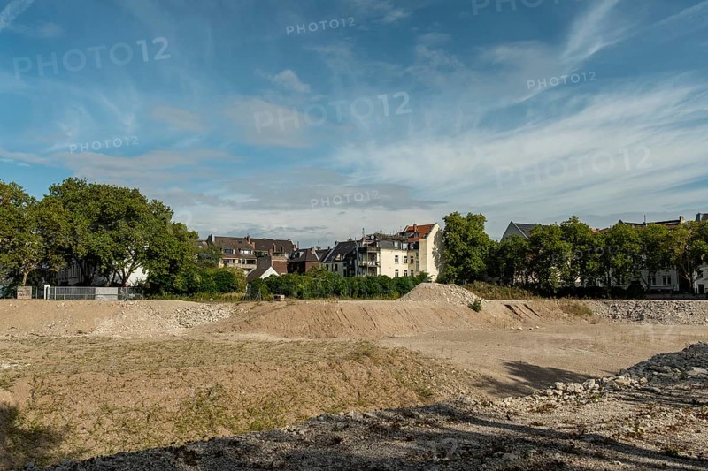 Excavation pit with houses in the background, Ehrenfeld, Cologne, North Rhine-Westphalia, Germany