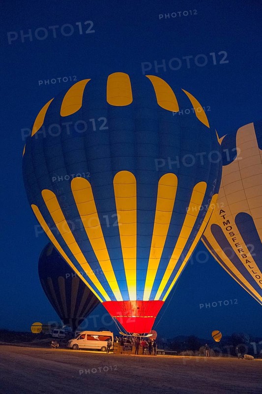 Various hot air balloons are prepared at night and light up the landscape, Göreme National Park, Göreme Tarihî Millî Parki, Nevsehir Province, Nevsehir, Cappadocia, Cappadocia, Cappadocia, Cappadocia, Central Anatolia, Turkey
