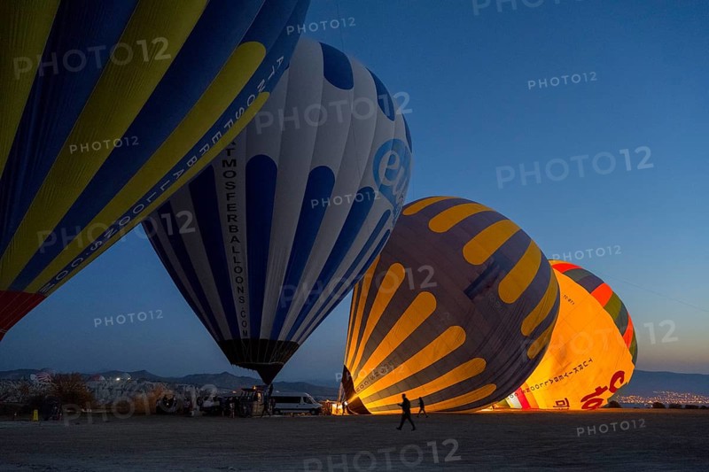 Hot air balloons are illuminated at night while the sky in the background is dark, Göreme National Park, Göreme Tarihî Millî Parki, Nevsehir Province, Nevsehir, Cappadocia, Cappadocia, Cappadocia, Cappadocia, Central Anatolia, Turkey