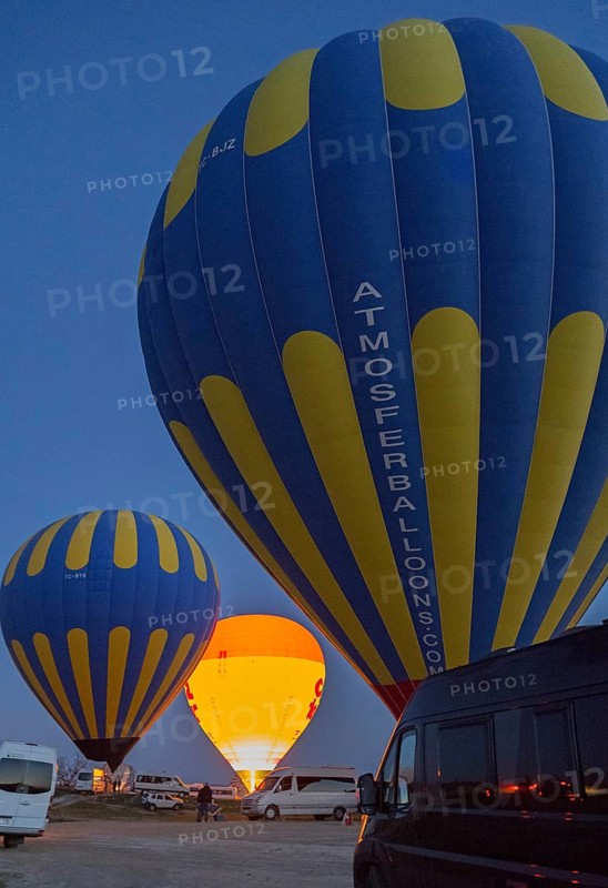 Hot air balloons stand ready at dusk, illuminated against a dark sky, camper, motorhome, Göreme National Park, Göreme Tarihî Millî Parki, Nevsehir Province, Nevsehir, Cappadocia, Cappadocia, Kapadokya, Cappadocia, Central Anatolia, Turkey