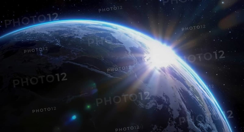 The sun rises over earth, illuminating the planet from space with a bright glow, surrounded by stars in a vast, dark cosmos, AI generated