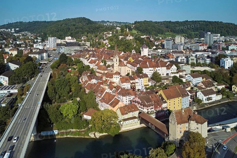 View of the old town with the parish church Maria Himmelfahrt, on the left the high bridge, behind the castle ruin Stein formerly an administrative centre of the Habsburgs, in front the river Limmat and the covered wooden bridge with the Landvogteischloss, Baden, Canton, Aargau, Switzerland