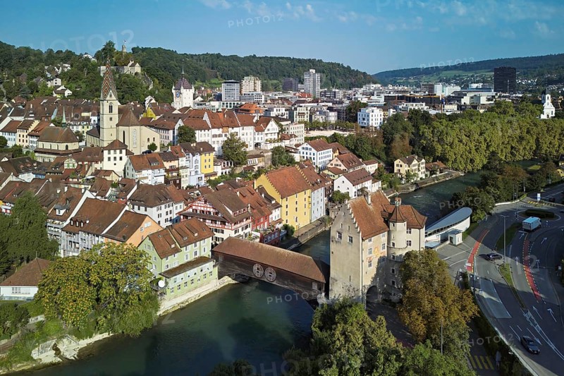 View of the old town with the parish church of Maria Himmelfahrt, in the background the ruins of Stein Castle, formerly an administrative centre of the Habsburgs, on the right the river Limmat and the covered wooden bridge with the Landvogteischloss, Baden, Canton, Aargau, Switzerland