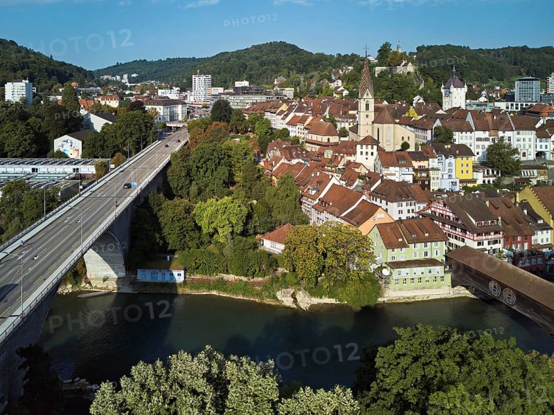 View of the old town with the parish church Maria Himmelfahrt, on the left the high bridge, behind the castle ruins Stein formerly an administrative centre of the Habsburgs, in front the river Limmat and the covered wooden bridge, Baden, Canton, Aargau, Switzerland