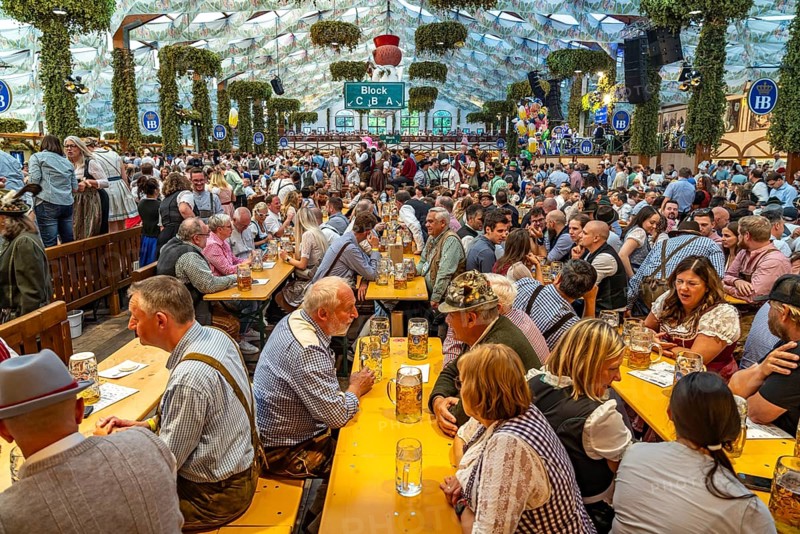 Visitors in the Hofbräu marquee at the Oktoberfest 2024 in Munich, Bavaria, Germany