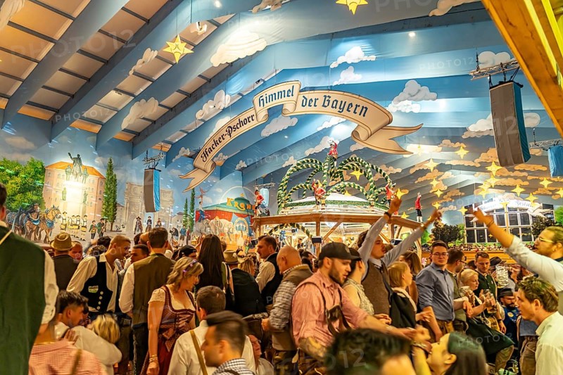 Visitors in the Hacker Pschorr marquee at the Oktoberfest 2024 in Munich, Bavaria, Germany