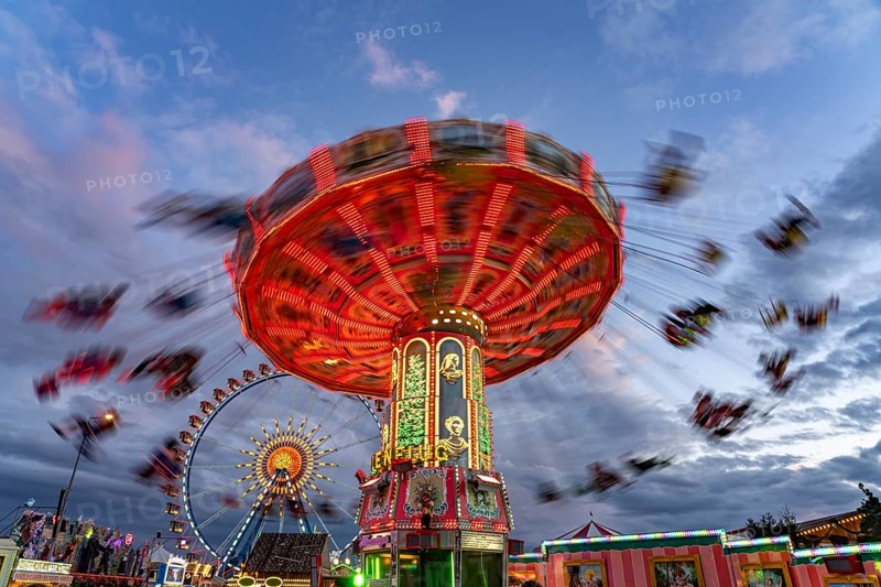 Chain carousel at Oktoberfest 2024 at dusk, Munich, Bavaria, Germany