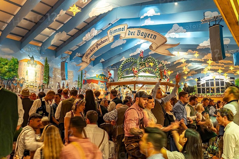 Visitors in the Hacker Pschorr marquee at the Oktoberfest 2024 in Munich, Bavaria, Germany