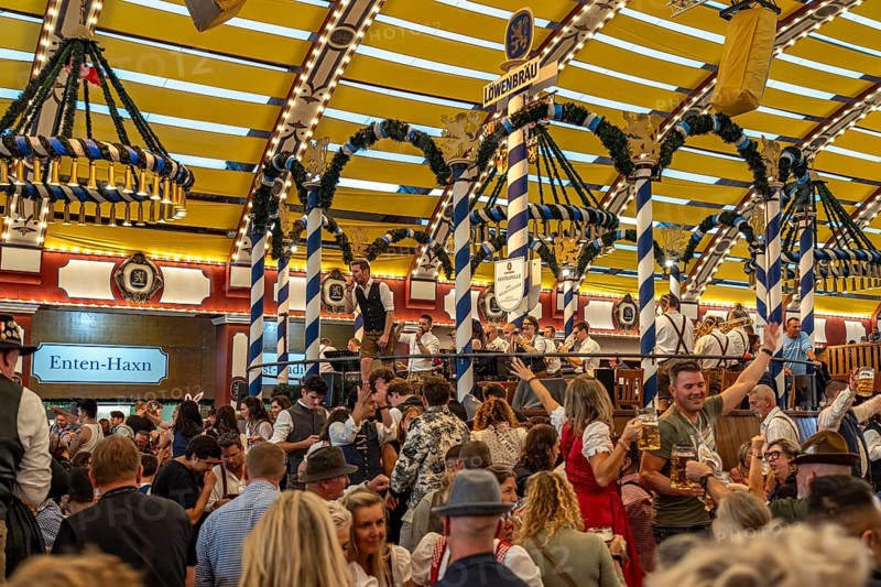 Visitors and band in the Löwenbräu marquee at the Oktoberfest 2024 in Munich, Bavaria, Germany
