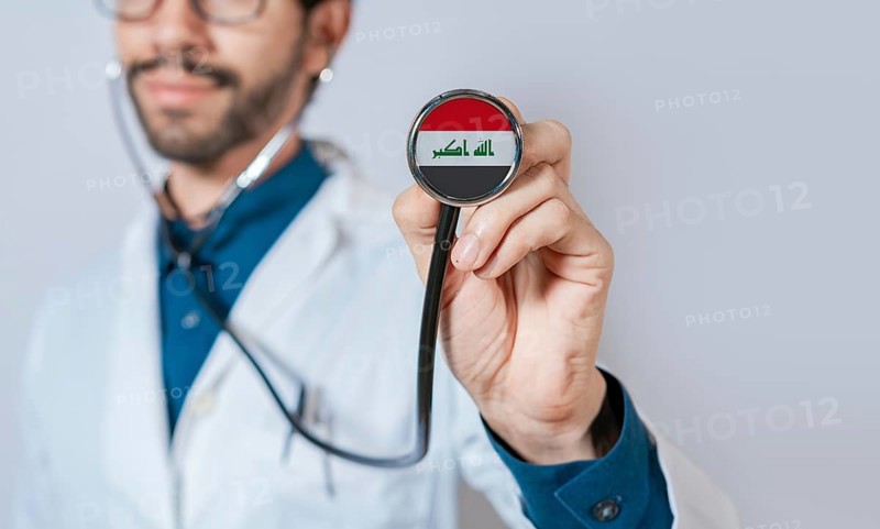 Doctor holding stethoscope with Iraq flag. Iraq health and care concept, Iraq flag on stethoscope