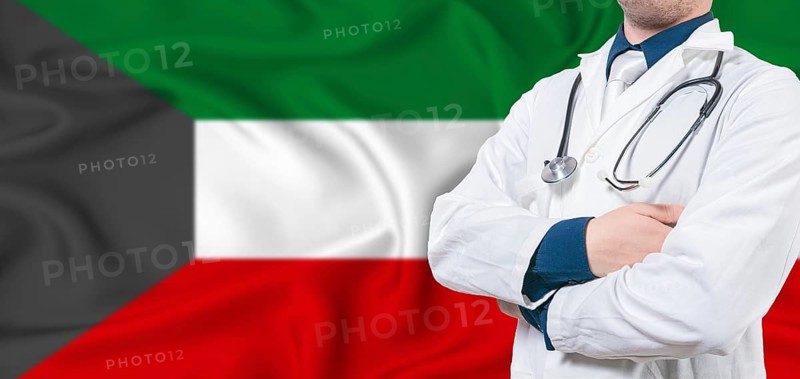 Kuwait healthcare concept. Male doctor on Kuwait flag. Doctor with crossed arms on Kuwait flag