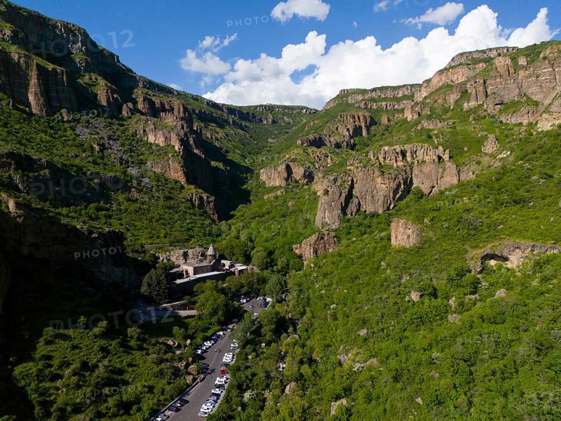 Valley with dense forest and a road leading through the scenery, aerial view, Geghard Monastery, UNESCO World Heritage Site, Kotayk Province, Armenia