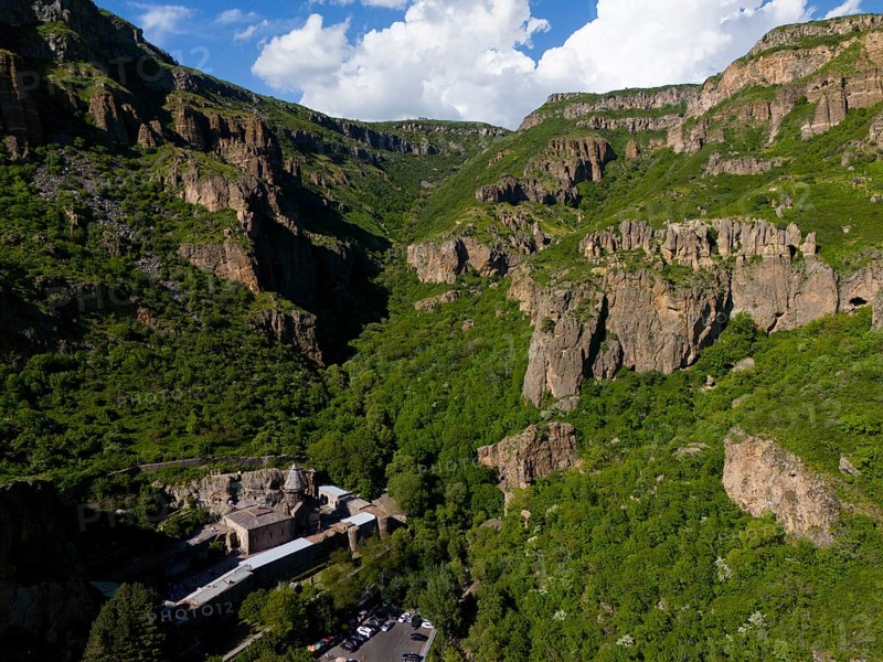 Gorge with lush greenery and rocks under a blue sky with clouds, aerial view, Geghard Monastery, UNESCO World Heritage Site, Kotayk Province, Armenia