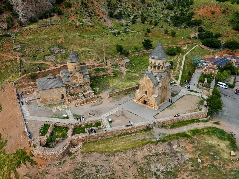 Close-up of an old stone church in a hilly landscape, aerial view, Noravank Monastery, Surb Astvatsatsin Mausoleum Church on the right and Surb Karapet Anabaptist Church on the left, Noravank, Vayots Dzor Province, Vayots Dzor, Armenia, Caucasus