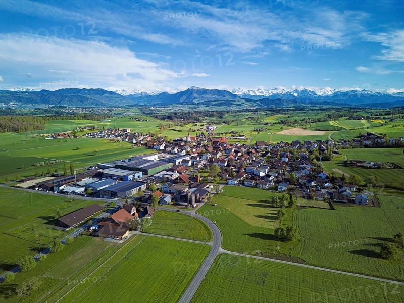 View of the village, in the foreground the industrial area, in the background the Rigi and the snow-covered Alps, Auw, Freiamt, Canton, Aargau, Switzerland