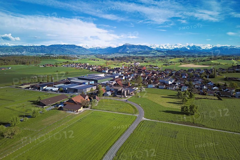 View of the village, in the foreground the industrial area, in the background the Rigi and the snow-covered Alps, Auw, Freiamt, Canton, Aargau, Switzerland
