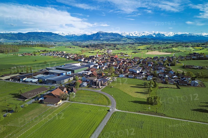 View of the village, in the foreground the industrial area, in the background the Rigi and the snow-covered Alps, Auw, Freiamt, Canton, Aargau, Switzerland