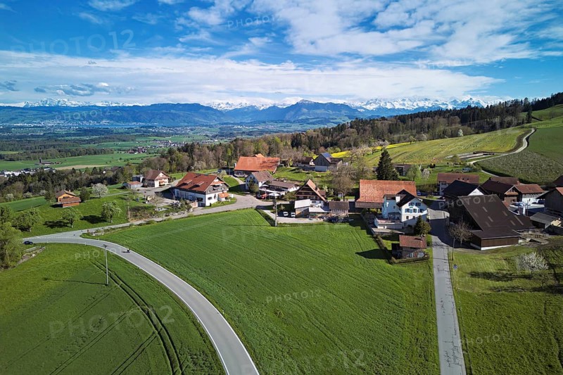 View of the hamlet of Brunnwil, behind the Rigi and the snow-covered Alps, Beinwil, Freiamt, Canton, Aargau, Switzerland