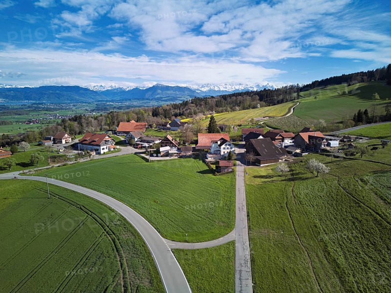 View of the hamlet of Brunnwil, behind the Rigi and the snow-covered Alps, Beinwil, Freiamt, Canton, Aargau, Switzerland