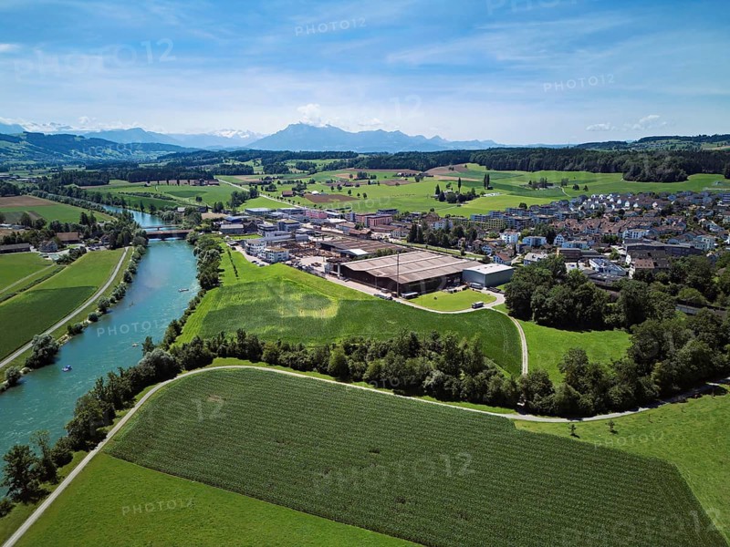 View of the village, industrial area on the right, Pilatus in the background, Sins, Freiamt, Canton Aargau, Switzerland