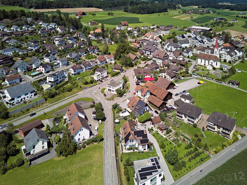 View of the village with the Roman Catholic parish church of St Anna, behind the Lindenberg, Mühlau, Freiamt, Canton, Aargau, Switzerland