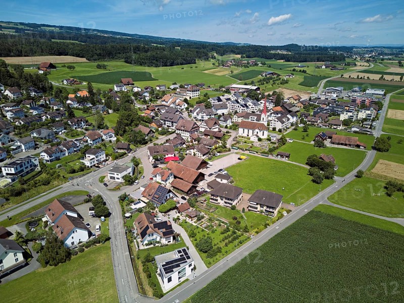 View of the village with the Roman Catholic parish church of St Anna, behind the Lindenberg, Mühlau, Freiamt, Canton, Aargau, Switzerland