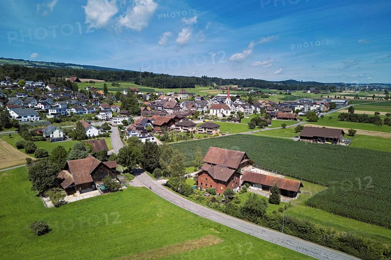 View of the village with the Roman Catholic parish church of St Anna, behind the Lindenberg, Mühlau, Freiamt, Canton, Aargau, Switzerland