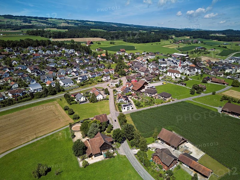 View of the village with the Roman Catholic parish church of St Anna, behind the Lindenberg, Mühlau, Freiamt, Canton, Aargau, Switzerland
