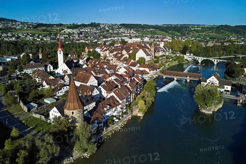 Old town with the Catholic Church of St. Nicholas, the tower of the Muri- Amthof and the witches' tower, on the right the Museum Reusskraftwerk Bruggmühle and the old wooden bridge over the river Reuss, Bremgarten, Freiamt, Canton, Aargau, Switzerland