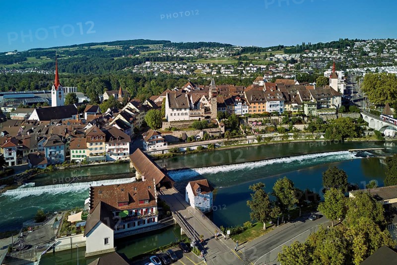 Old town with the Catholic Church of St Nicholas and the tower of the Muri- Amthof, in the foreground the weir and the old wooden bridge over the river Reuss, Bremgarten, Freiamt, Canton, Aargau, Switzerland