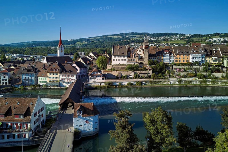 Old town with the Catholic Church of St Nicholas and the tower of the Muri- Amthof, in the foreground the weir and the old wooden bridge over the river Reuss, Bremgarten, Freiamt, Canton, Aargau, Switzerland