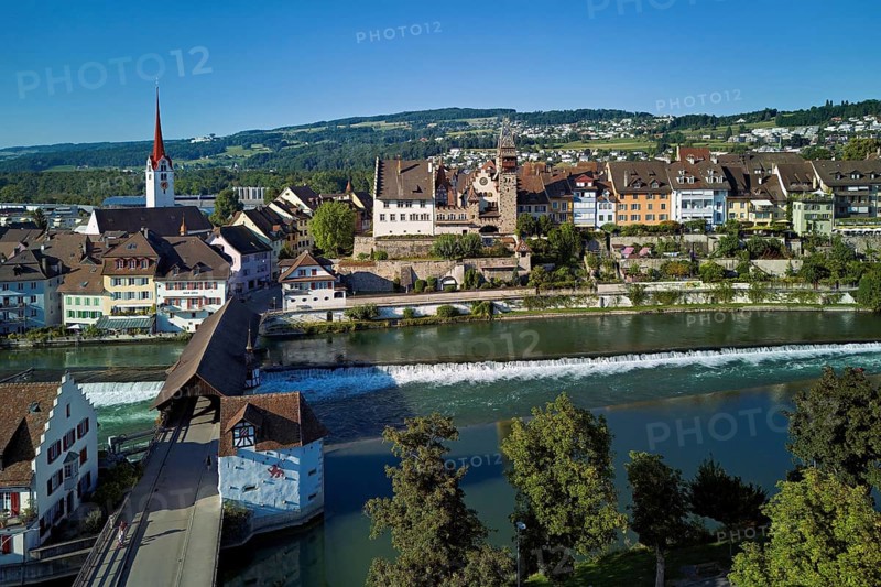 Old town with the Catholic Church of St Nicholas and the tower of the Muri- Amthof, in the foreground the weir and the old wooden bridge over the river Reuss, Bremgarten, Freiamt, Canton, Aargau, Switzerland