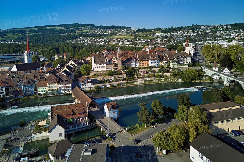 Old town with the Catholic Church of St Nicholas and the tower of the Muri- Amthof, in the foreground the weir and the old wooden bridge over the river Reuss, Bremgarten, Freiamt, Canton, Aargau, Switzerland