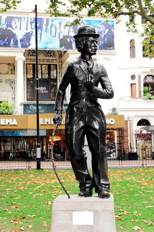London, England, Great Britain, Europe, Bronze statue of Charlie Chaplin in front of a cinema in a park with autumn leaves